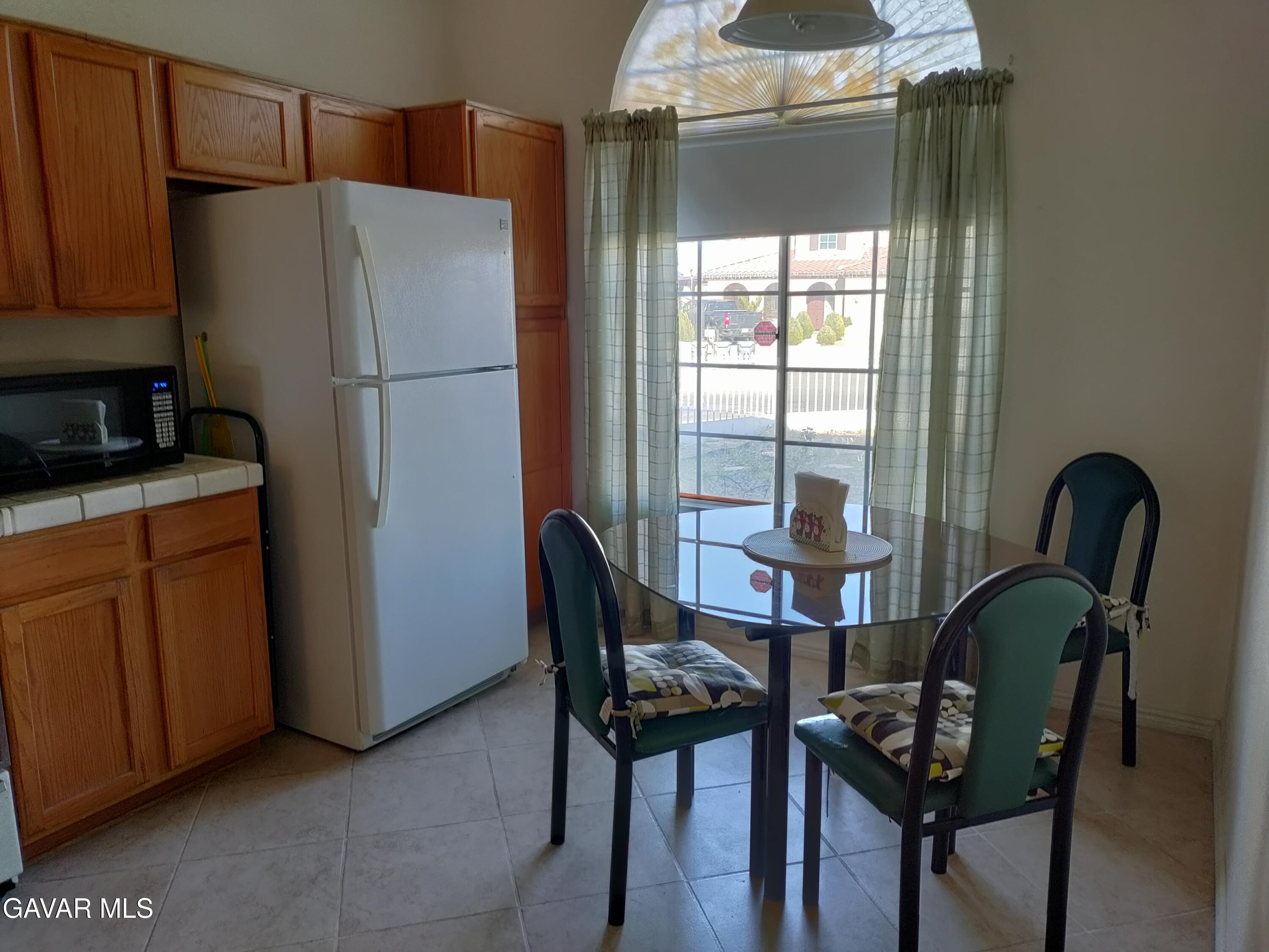 37759 67th Street East Palmdale, CA 93552 - Photo 5 of 27 a kitchen with granite countertop cabinets and refrigerator