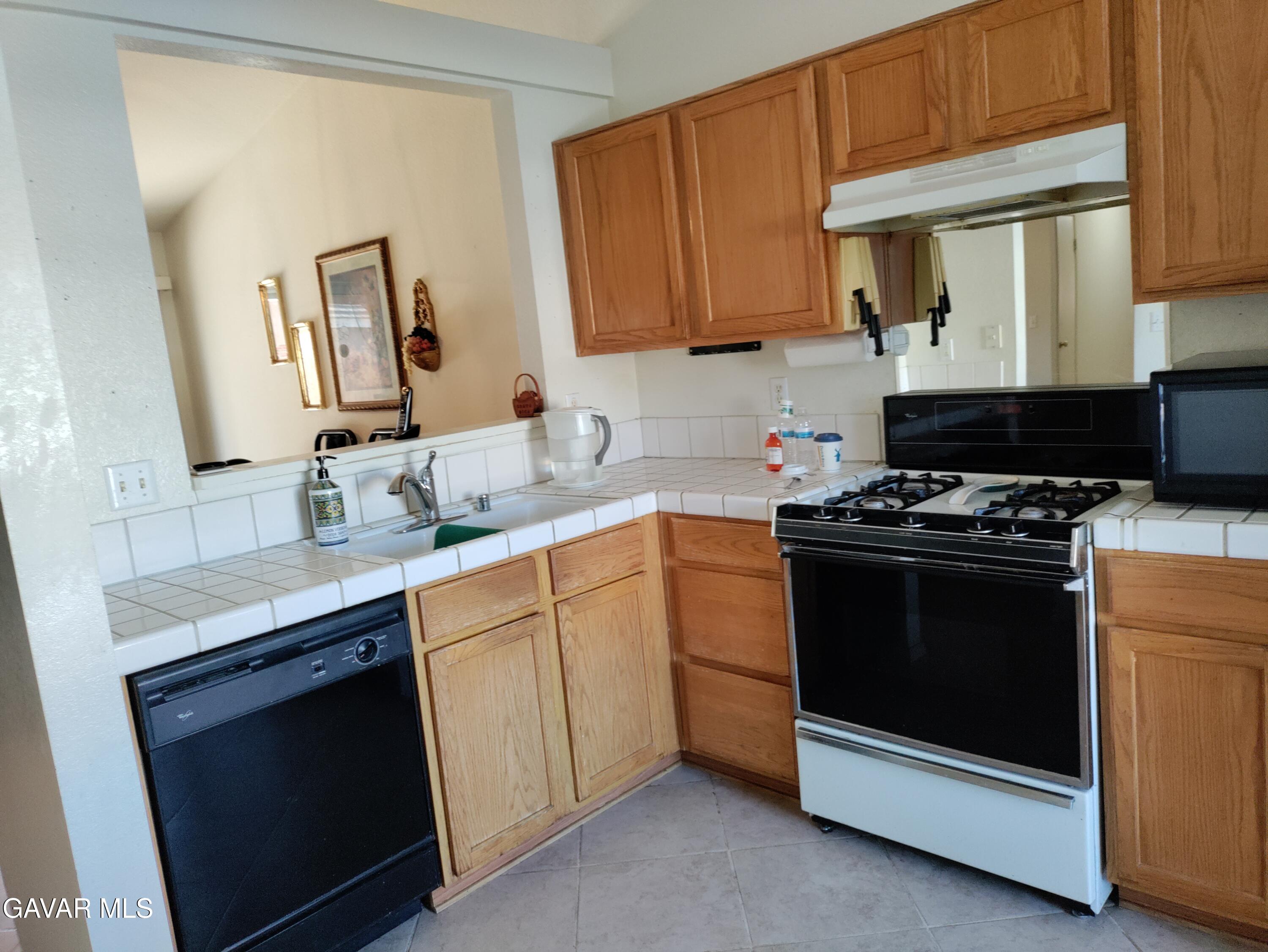 37759 67th Street East Palmdale, CA 93552 - Photo 6 of 27 a kitchen with a sink stove and microwave