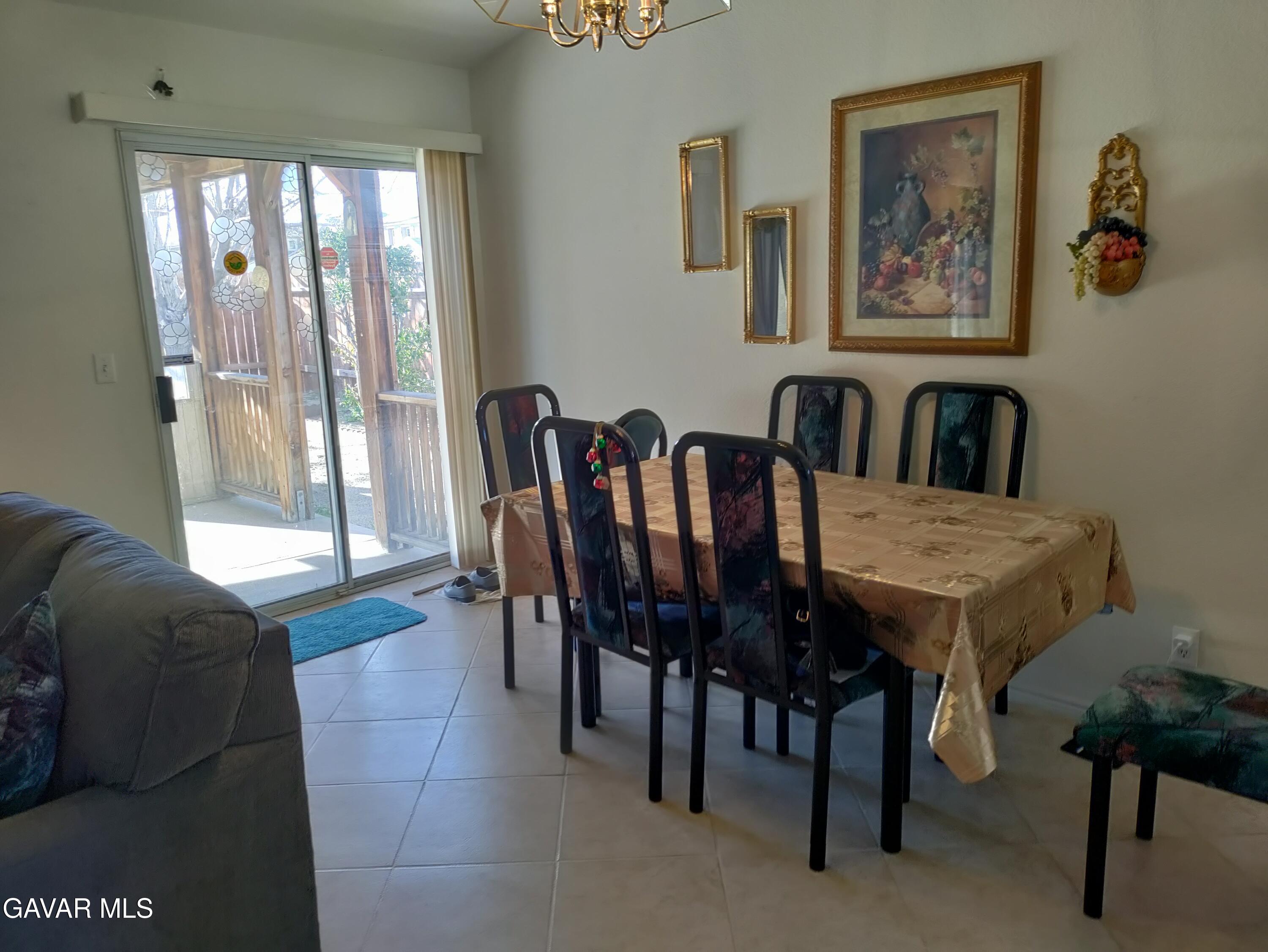 37759 67th Street East Palmdale, CA 93552 - Photo 7 of 27 a view of a dining room with furniture and a large window