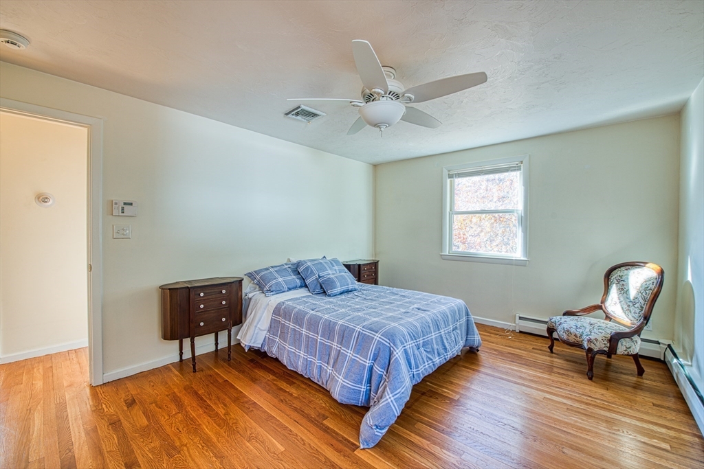 40 Lyndon Road Sharon, MA 02067 - Photo 13 of 23 a bedroom with a bed a chair and a potted plant on a dresser