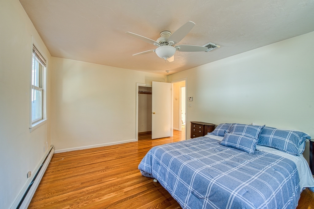40 Lyndon Road Sharon, MA 02067 - Photo 14 of 23 a bedroom with a large bed and a chandelier