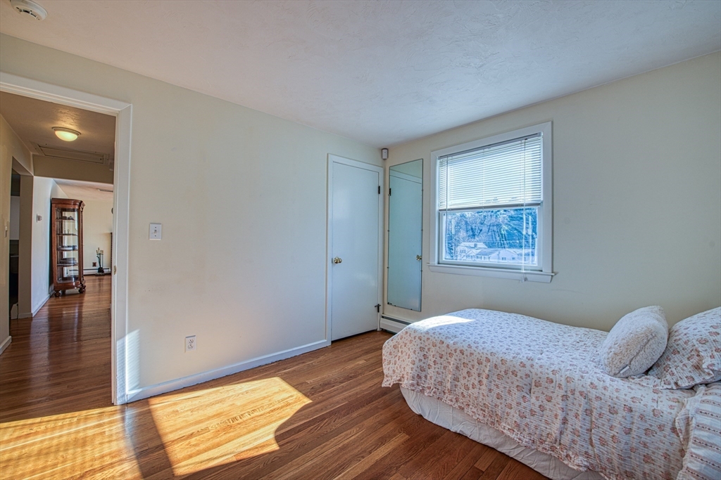 40 Lyndon Road Sharon, MA 02067 - Photo 16 of 23 a bedroom with a bed and wooden floor