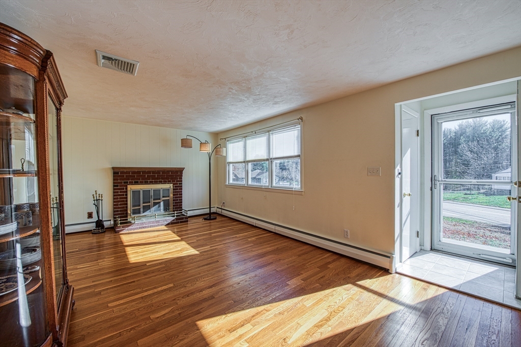 40 Lyndon Road Sharon, MA 02067 - Photo 4 of 23 a view of an empty room with glass door and windows