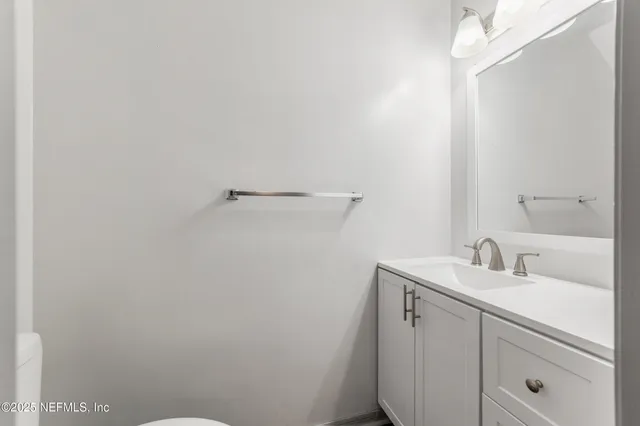 a bathroom with a sink vanity and a mirror