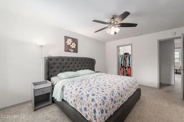 a view of walk in closet with clothes