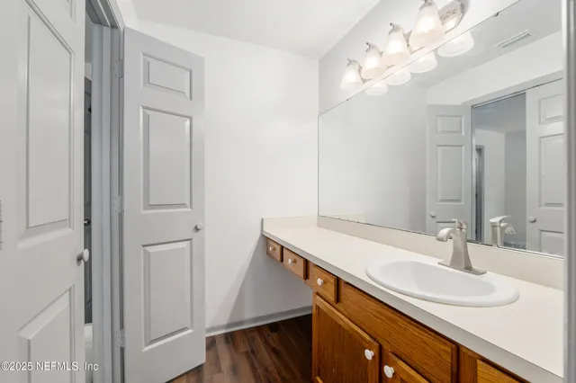 a bathroom with a granite countertop sink a toilet and shower