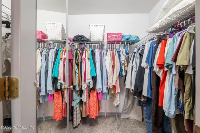 a view of backyard with table and chairs and large trees