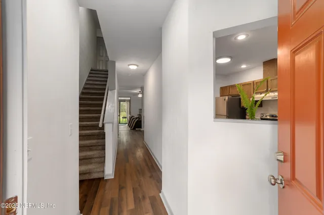 a view of hallway with wooden floor