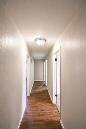 a view of hallway with wooden floor