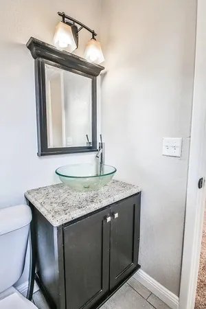 a bathroom with a toilet sink and mirror