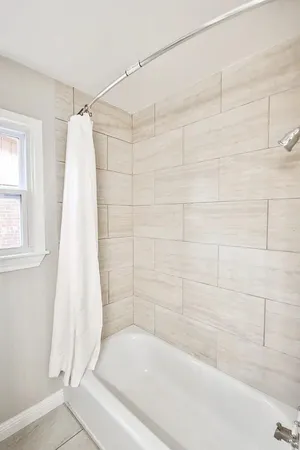 a bathroom with a bathtub and a shower
