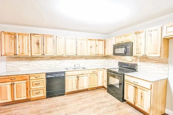 a kitchen with stainless steel appliances granite countertop a stove and cabinets