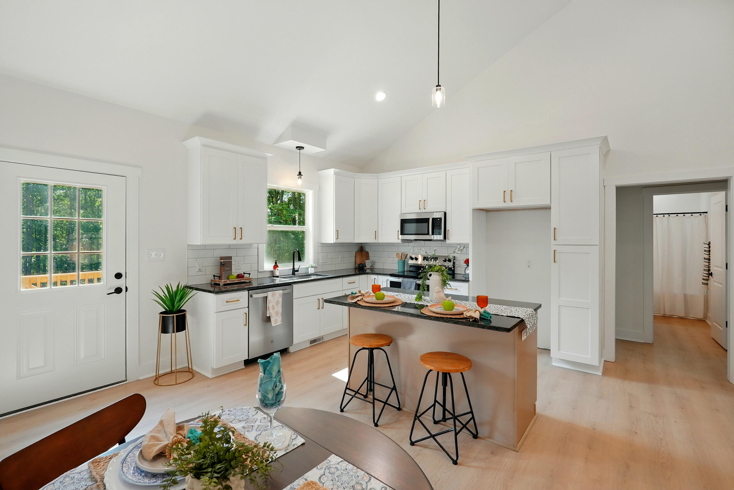 Lot 20 Johnson Mountain Road Huddleston, VA 24104 - Photo 13 of 30 a kitchen with stainless steel appliances kitchen island granite countertop a stove refrigerator and cabinets