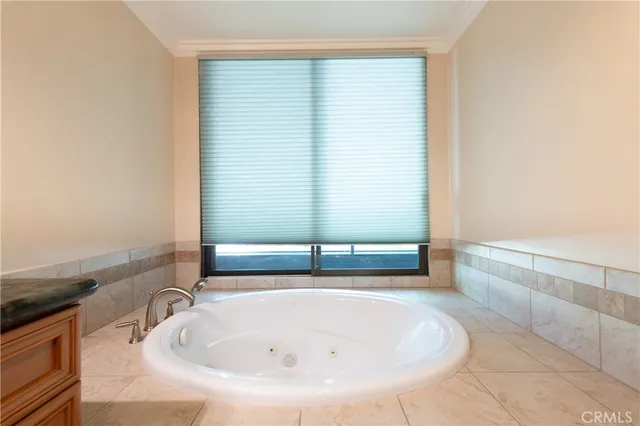 a view of walk in closet with clothes