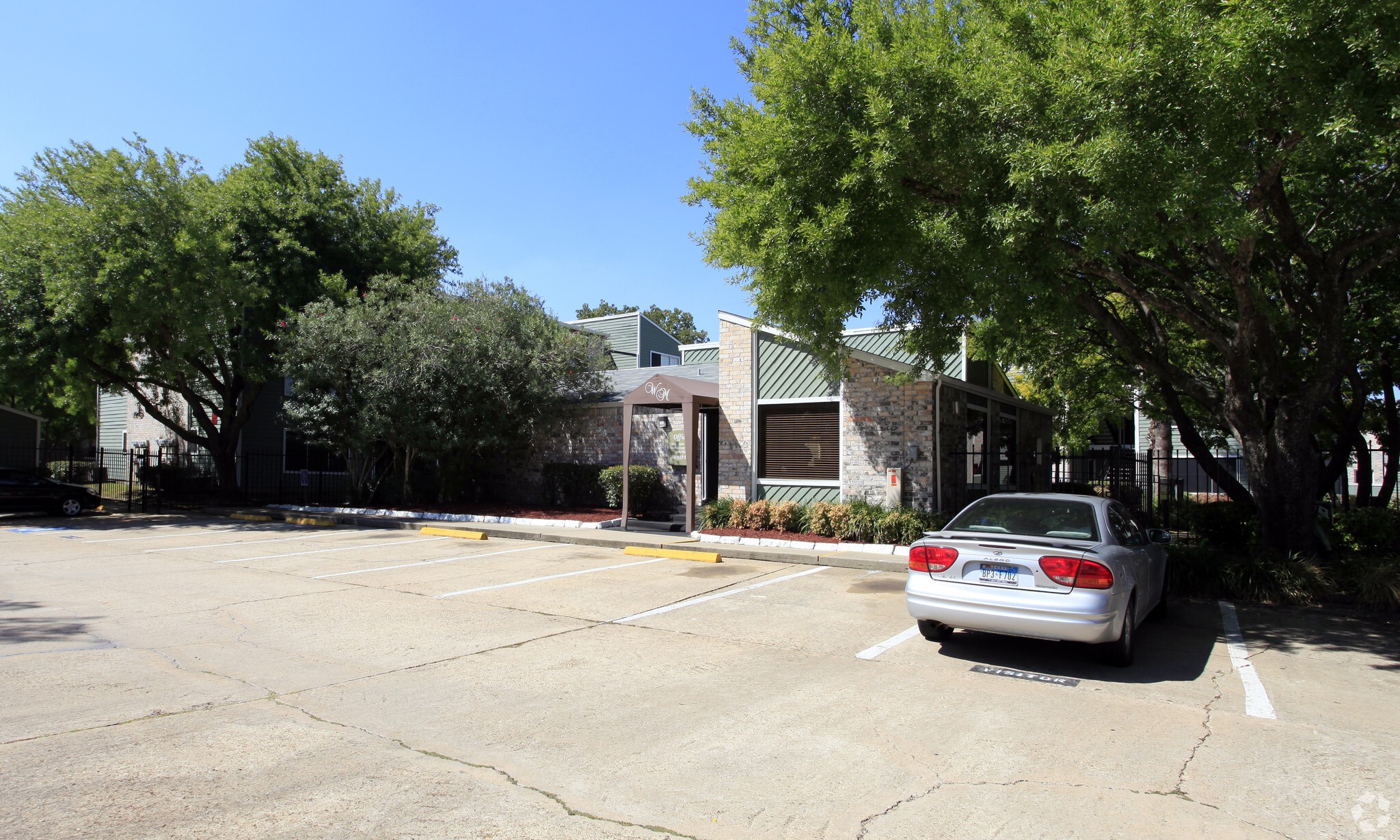 10250 Lands End Drive, Unit 410 Houston, TX 77099 - Photo 22 of 27 a car parked in front of house with trees