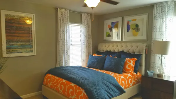 a bed sitting in a bedroom next to a window