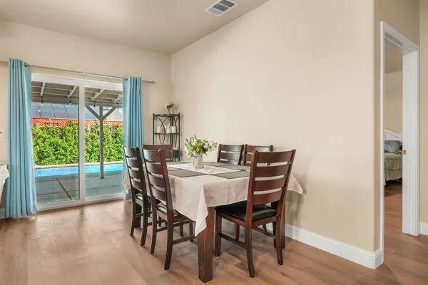 a view of a dining room with furniture window and wooden floor