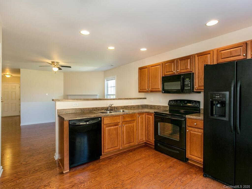 244 Lumber River Road Fletcher, NC 28732 - Photo 12 of 36 a kitchen with stainless steel appliances granite countertop a stove a sink and a refrigerator