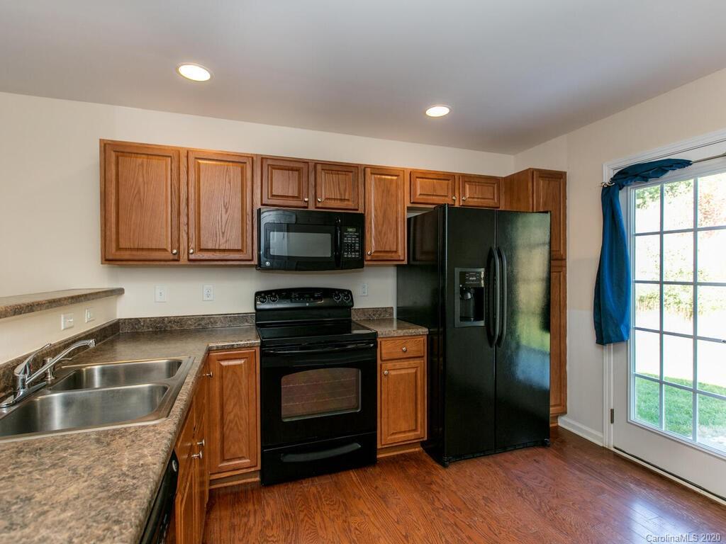 244 Lumber River Road Fletcher, NC 28732 - Photo 14 of 36 a kitchen with stainless steel appliances granite countertop a refrigerator microwave and sink