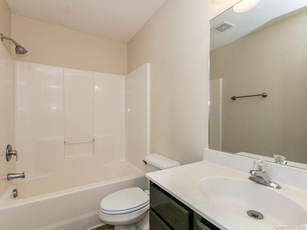 244 Lumber River Road Fletcher, NC 28732 - Photo 21 of 36 a bathroom with a sink a toilet and shower