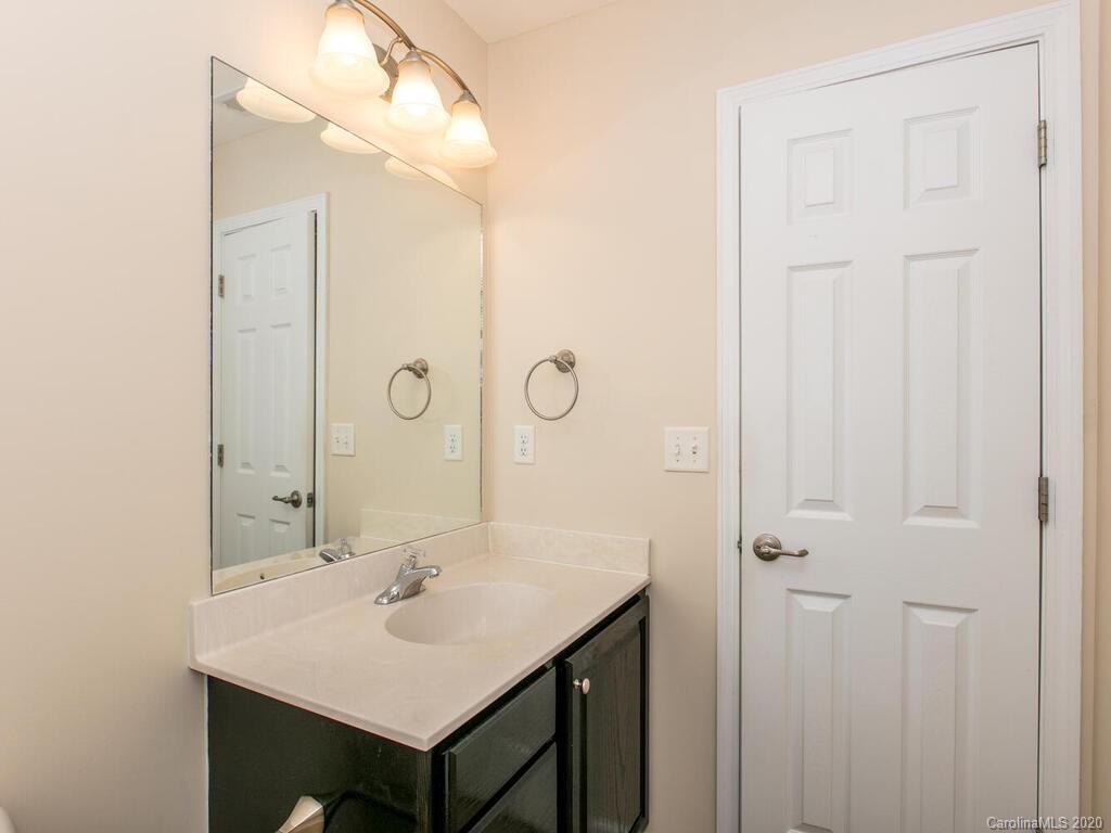 244 Lumber River Road Fletcher, NC 28732 - Photo 22 of 36 a bathroom with a sink and a mirror