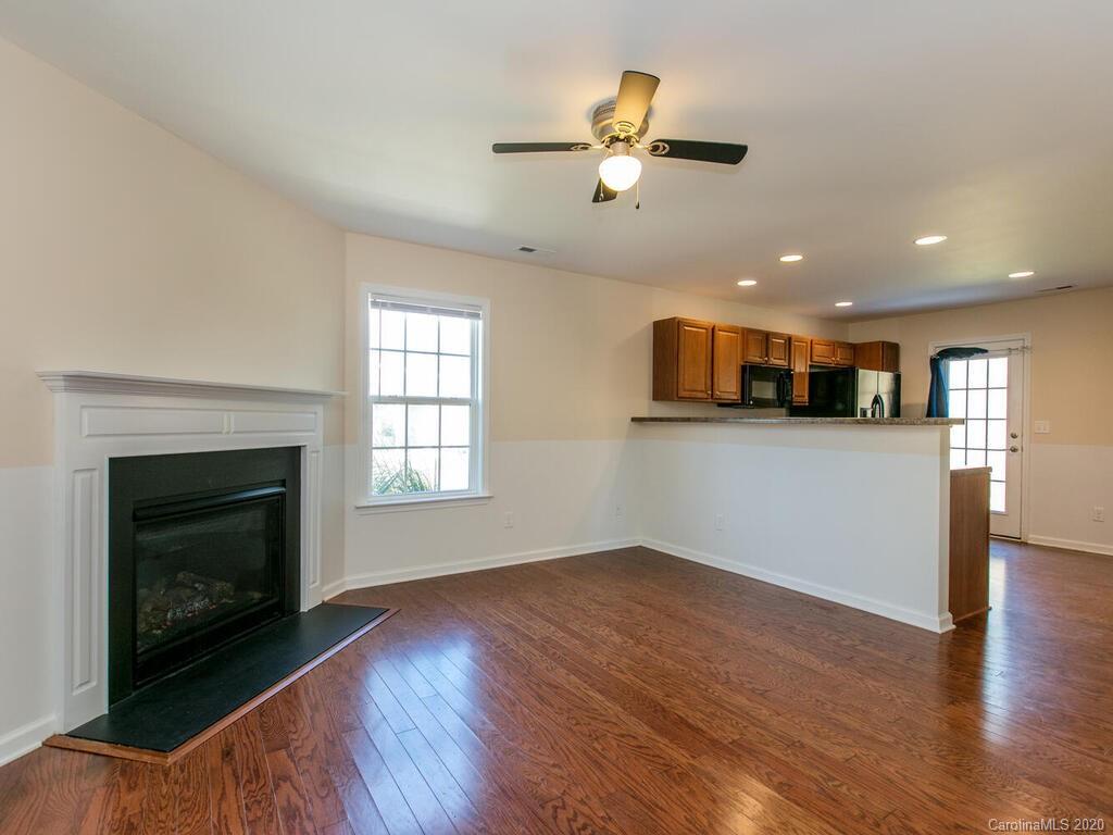 244 Lumber River Road Fletcher, NC 28732 - Photo 7 of 36 a view of a livingroom with wooden floor and a fireplace
