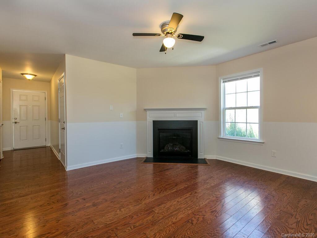 244 Lumber River Road Fletcher, NC 28732 - Photo 8 of 36 a view of empty room with wooden floor and fan