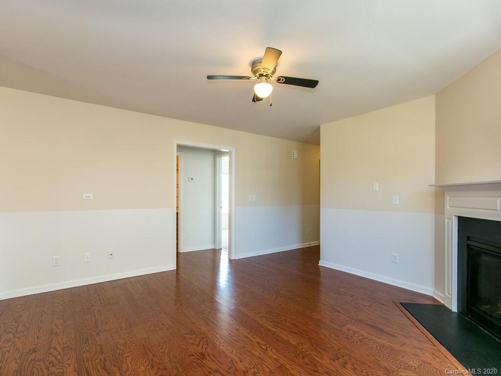 244 Lumber River Road Fletcher, NC 28732 - Photo 9 of 36 a view of empty room with wooden floor and fan