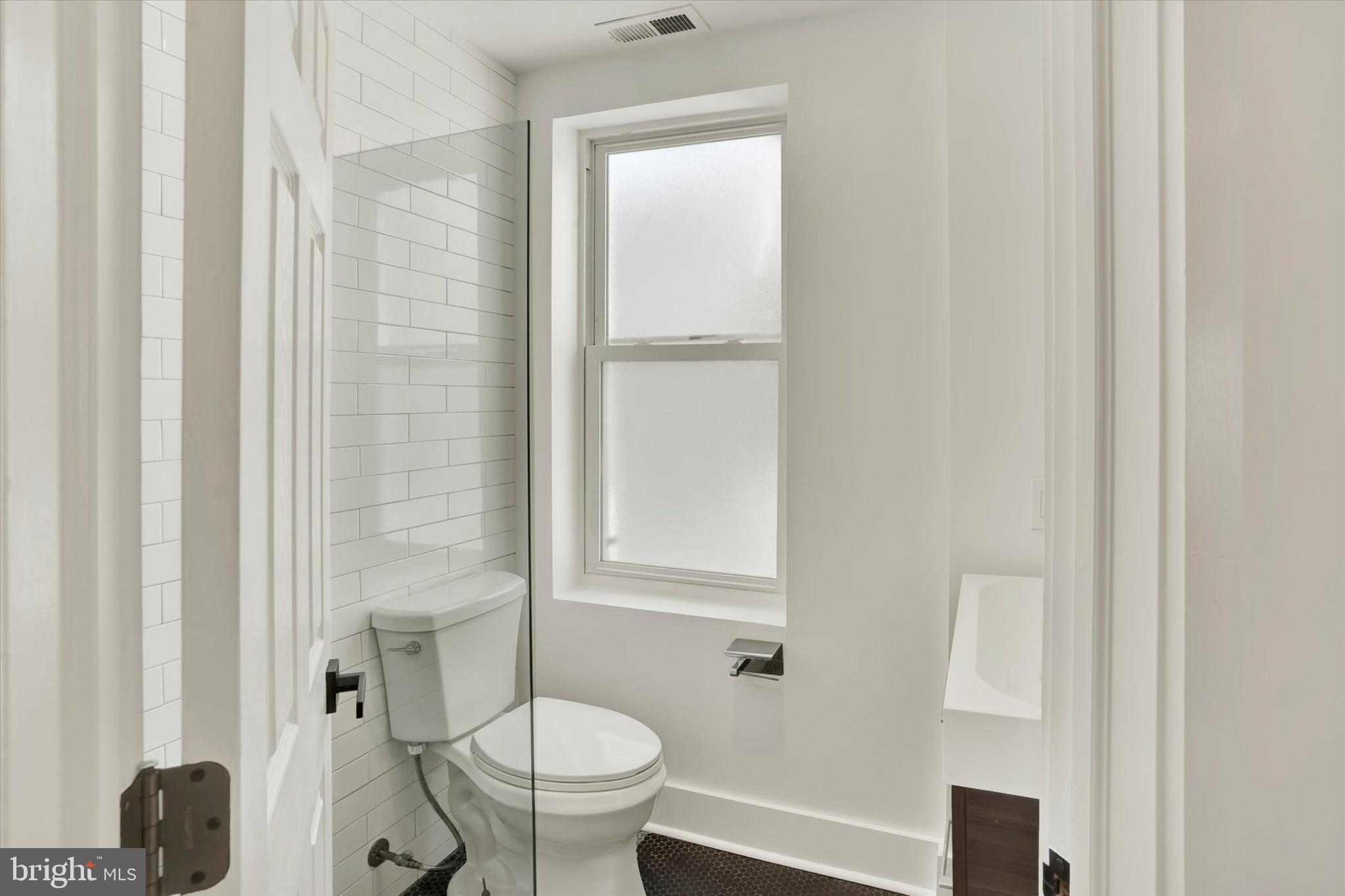 2636 Manton Street Philadelphia, PA 19146 - Photo 18 of 36 a bathroom with a toilet a sink and a mirror