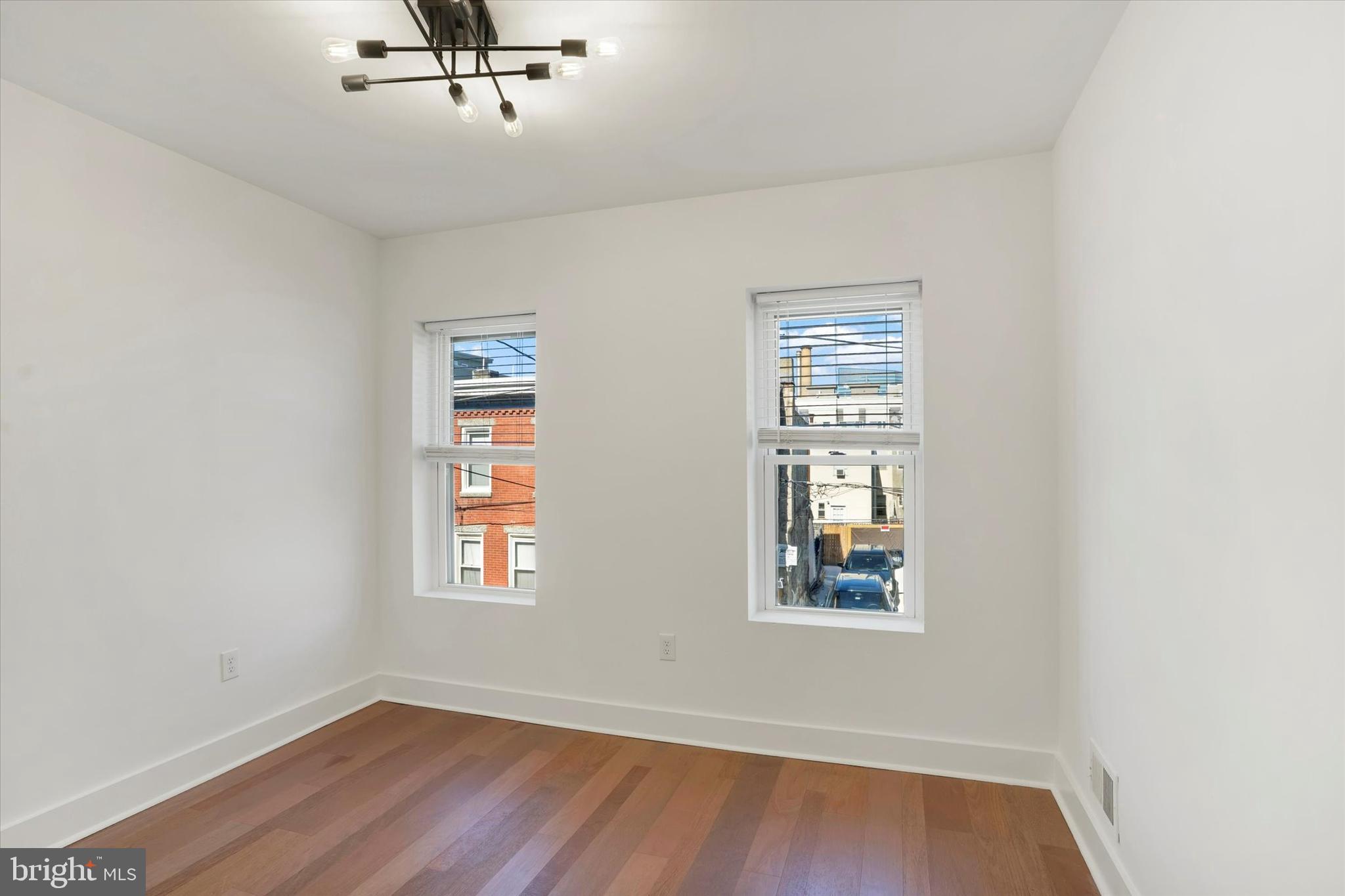 2636 Manton Street Philadelphia, PA 19146 - Photo 22 of 36 a view of an empty room with wooden floor and a window