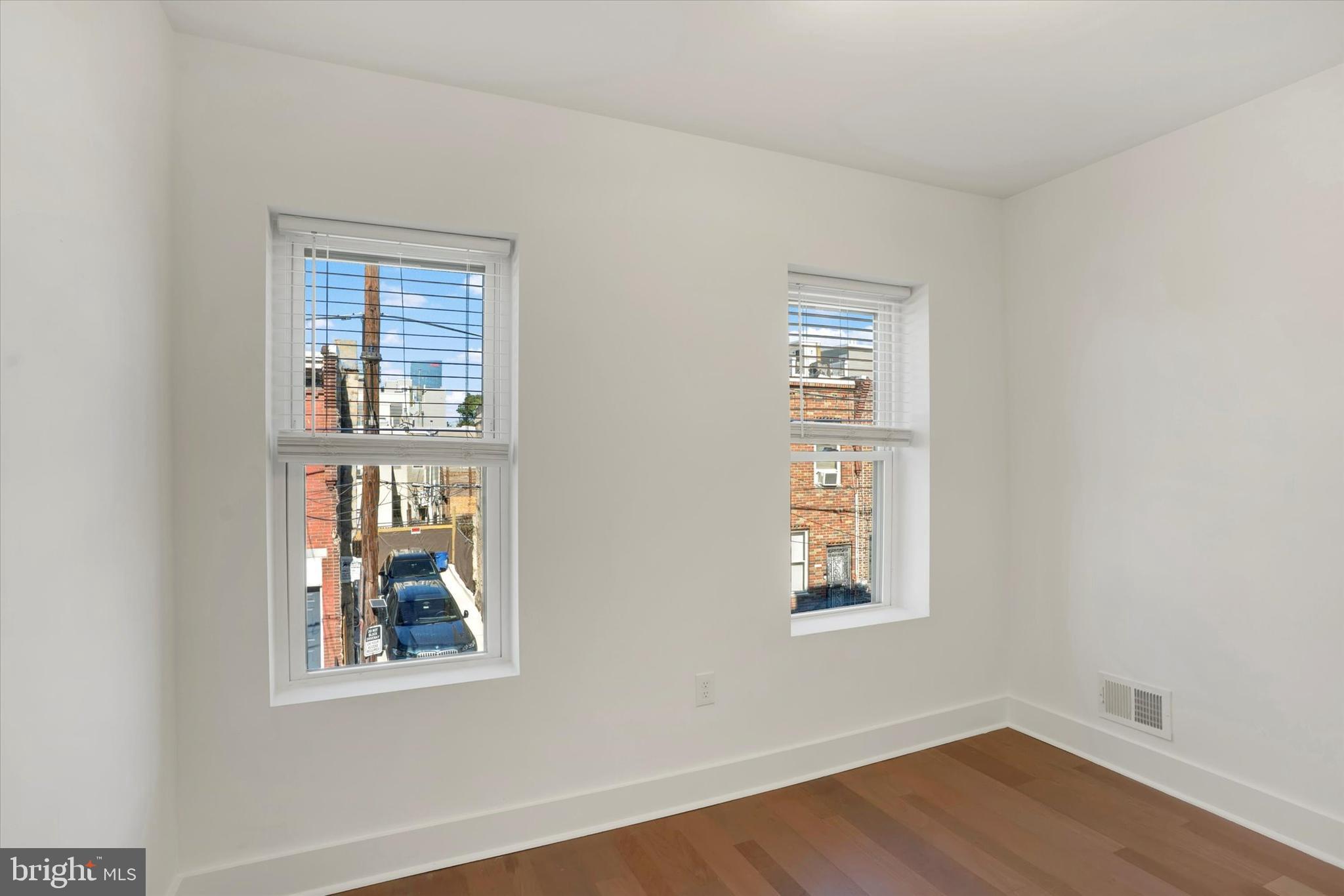 2636 Manton Street Philadelphia, PA 19146 - Photo 23 of 36 a view of an empty room with wooden floor and a window