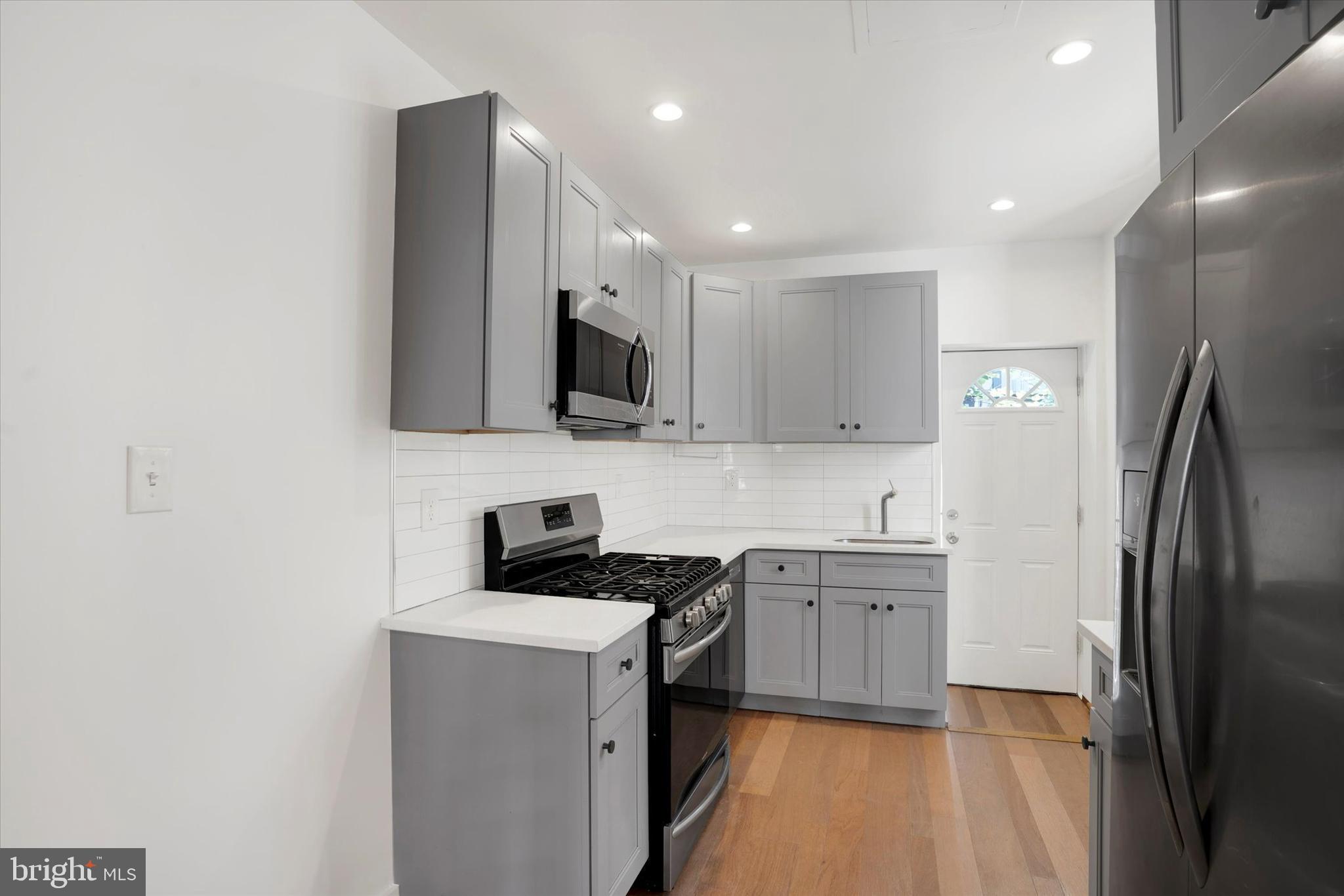 2636 Manton Street Philadelphia, PA 19146 - Photo 9 of 36 a kitchen with stainless steel appliances a sink stove and refrigerator