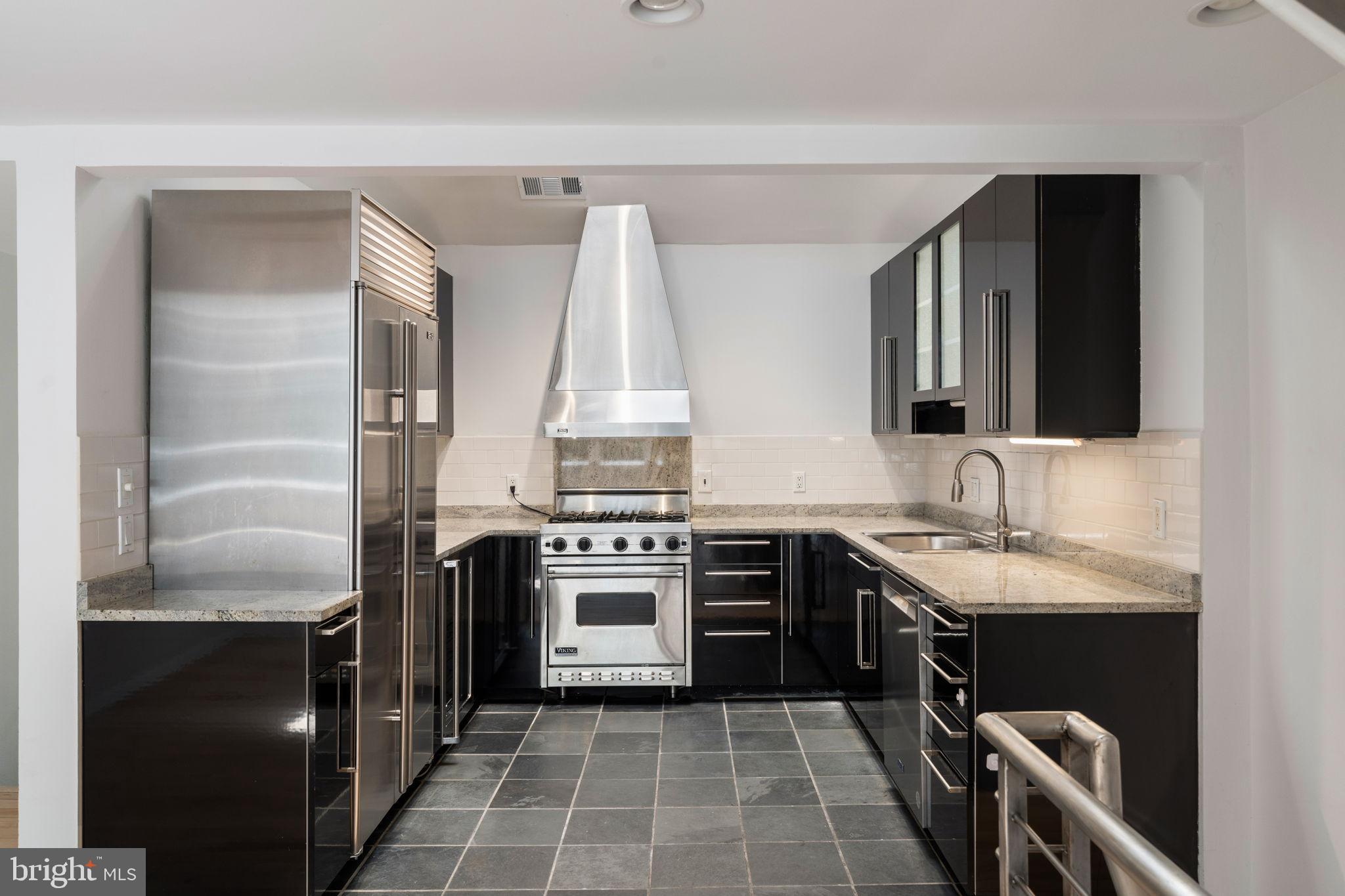 2036 Rittenhouse Square Philadelphia, PA 19103 - Photo 14 of 39 a kitchen with a sink stove and cabinets