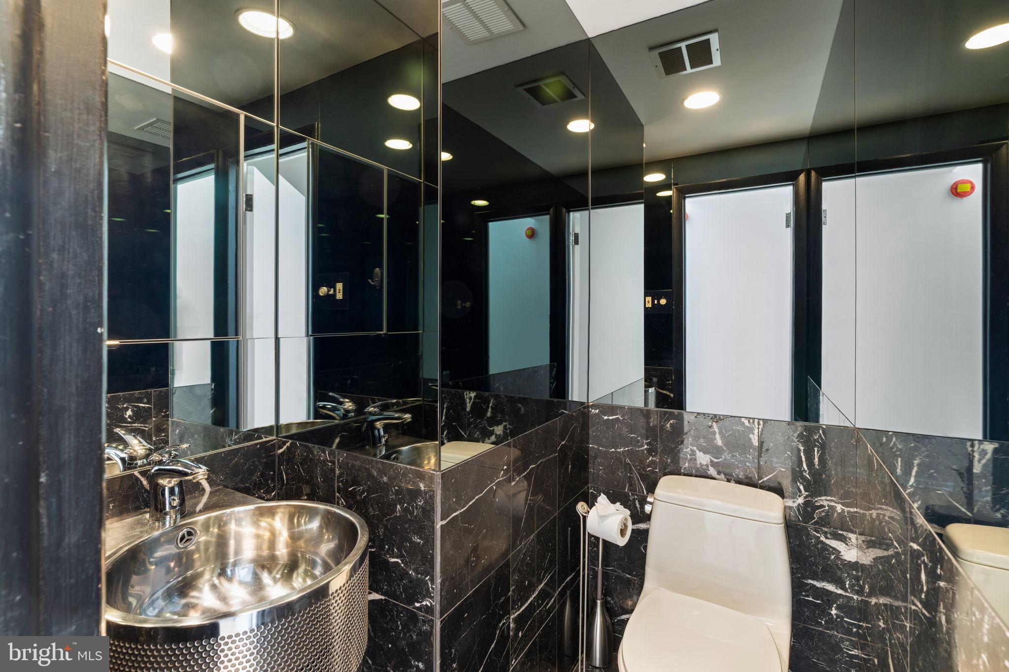 2036 Rittenhouse Square Philadelphia, PA 19103 - Photo 17 of 39 a bathroom with a double vanity sink and a mirror