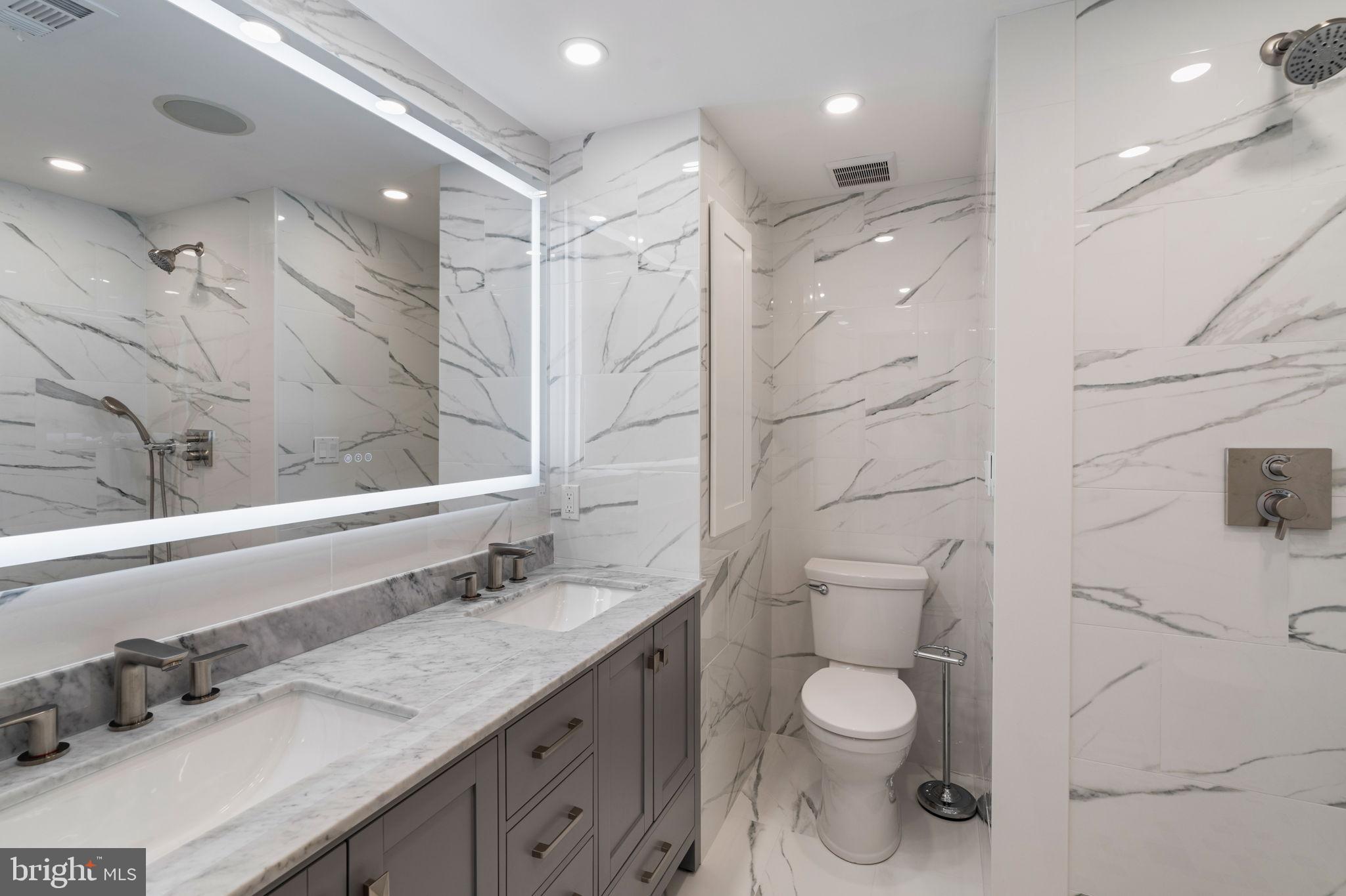 2036 Rittenhouse Square Philadelphia, PA 19103 - Photo 23 of 39 a bathroom with a granite countertop sink a toilet and shower