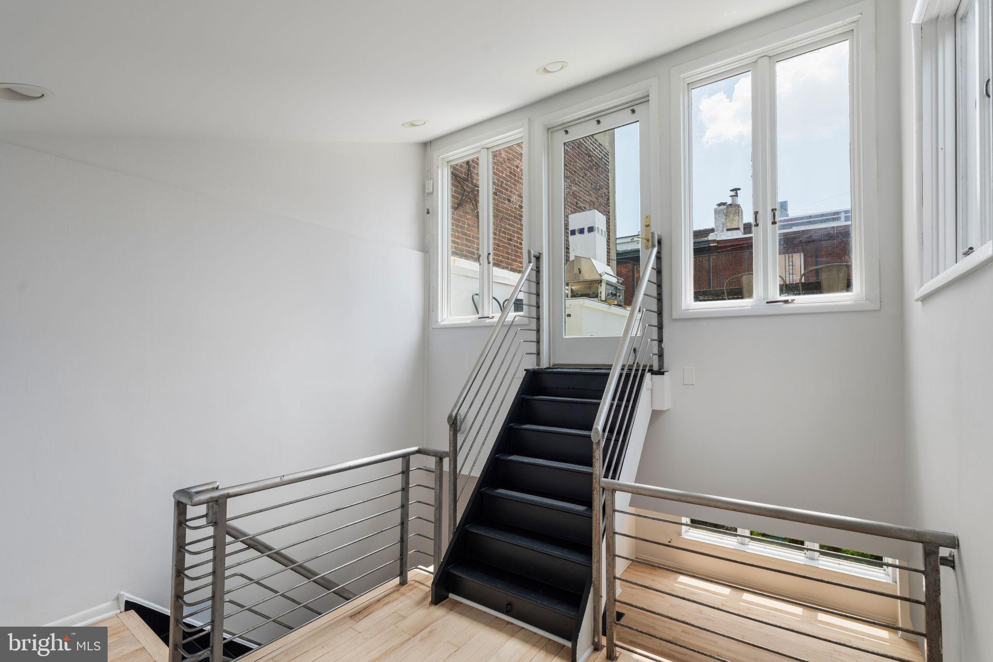 2036 Rittenhouse Square Philadelphia, PA 19103 - Photo 26 of 39 a view of staircase with lots of frames on wall and a window