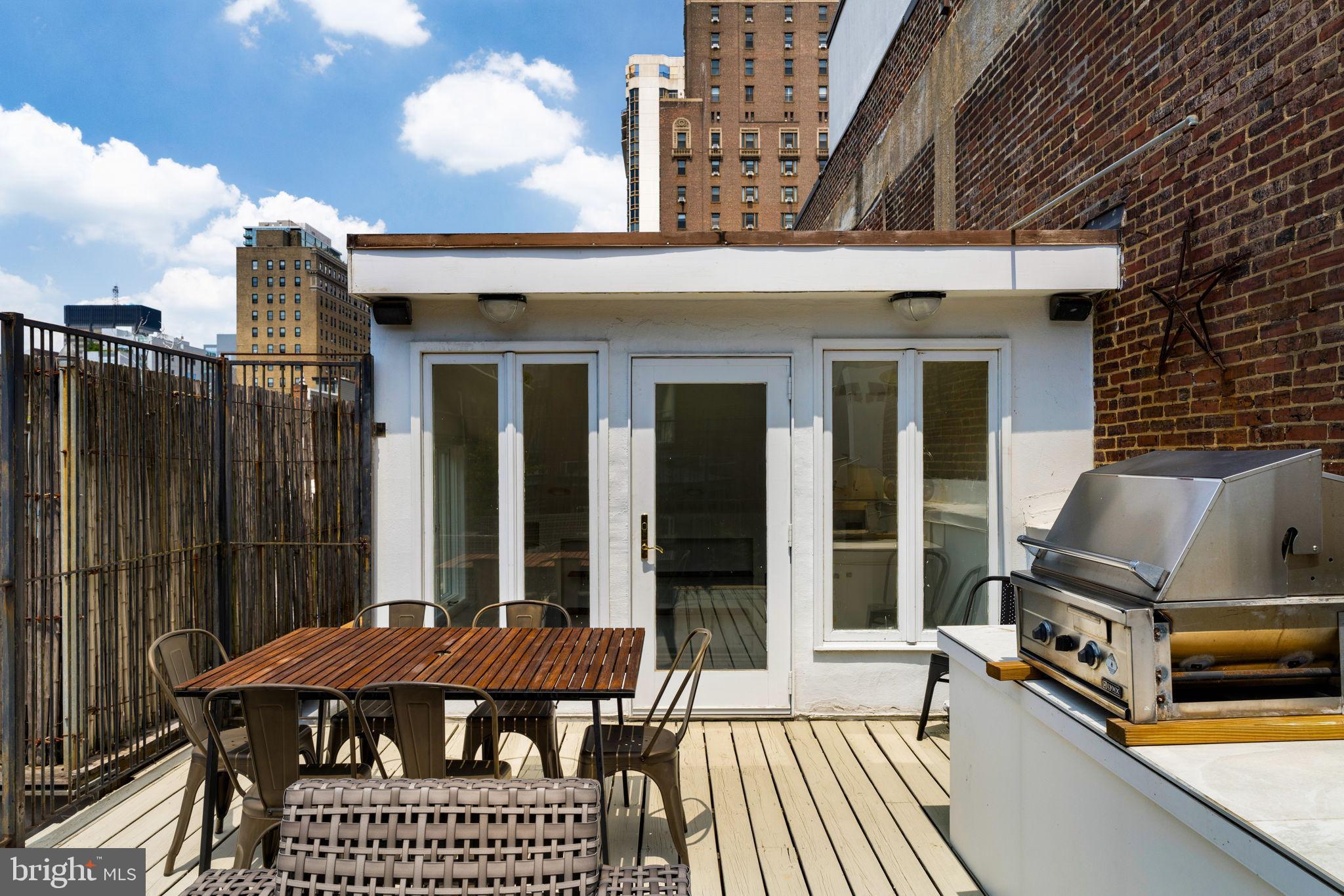 2036 Rittenhouse Square Philadelphia, PA 19103 - Photo 27 of 39 a view of a patio with table and chairs with wooden floor and fence