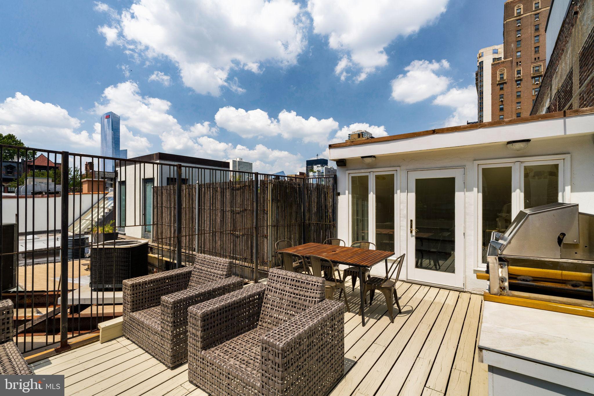2036 Rittenhouse Square Philadelphia, PA 19103 - Photo 30 of 39 a roof deck with table and chairs and potted plants