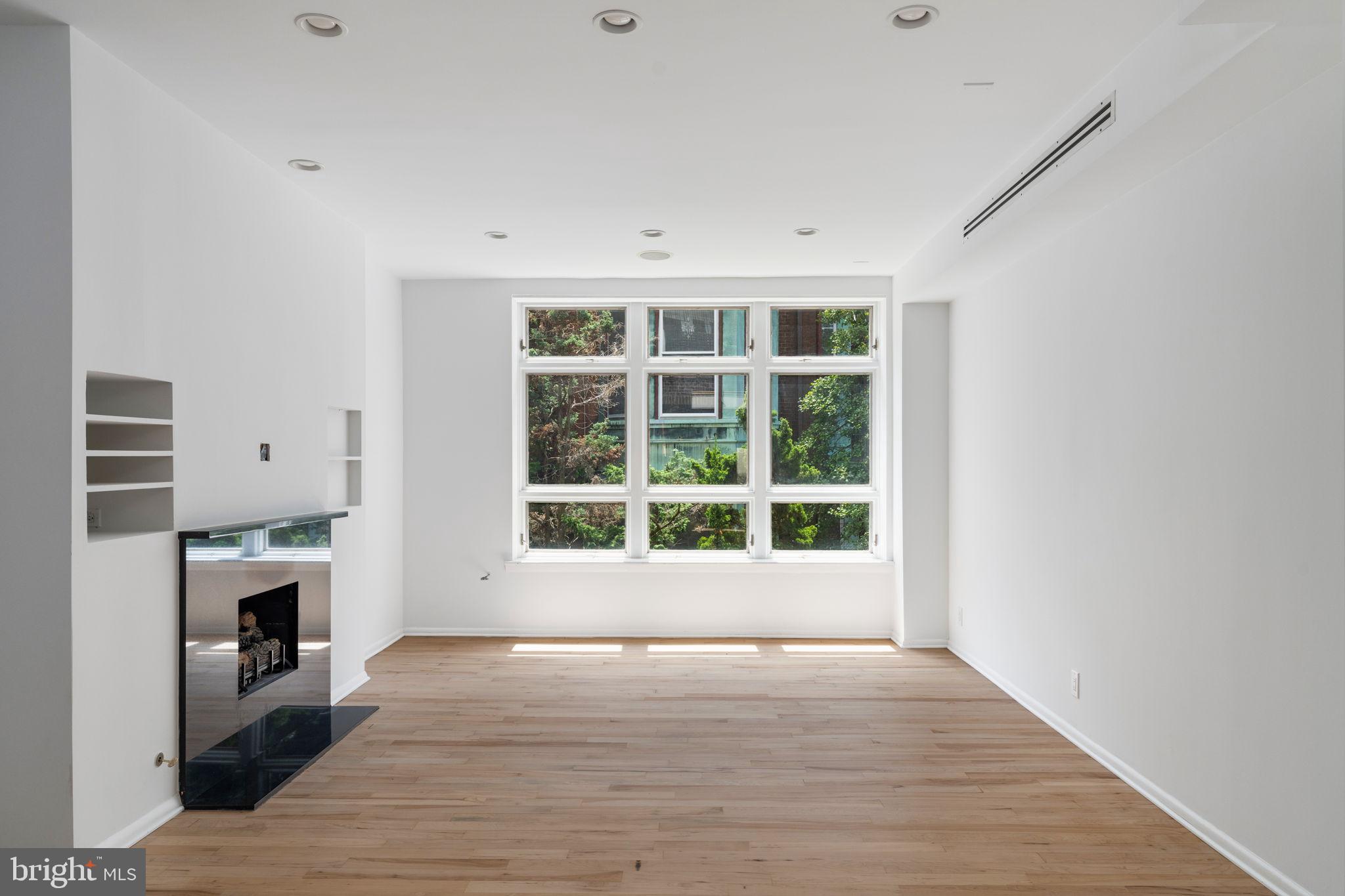 2036 Rittenhouse Square Philadelphia, PA 19103 - Photo 6 of 39 a view of empty room with wooden floor and fireplace