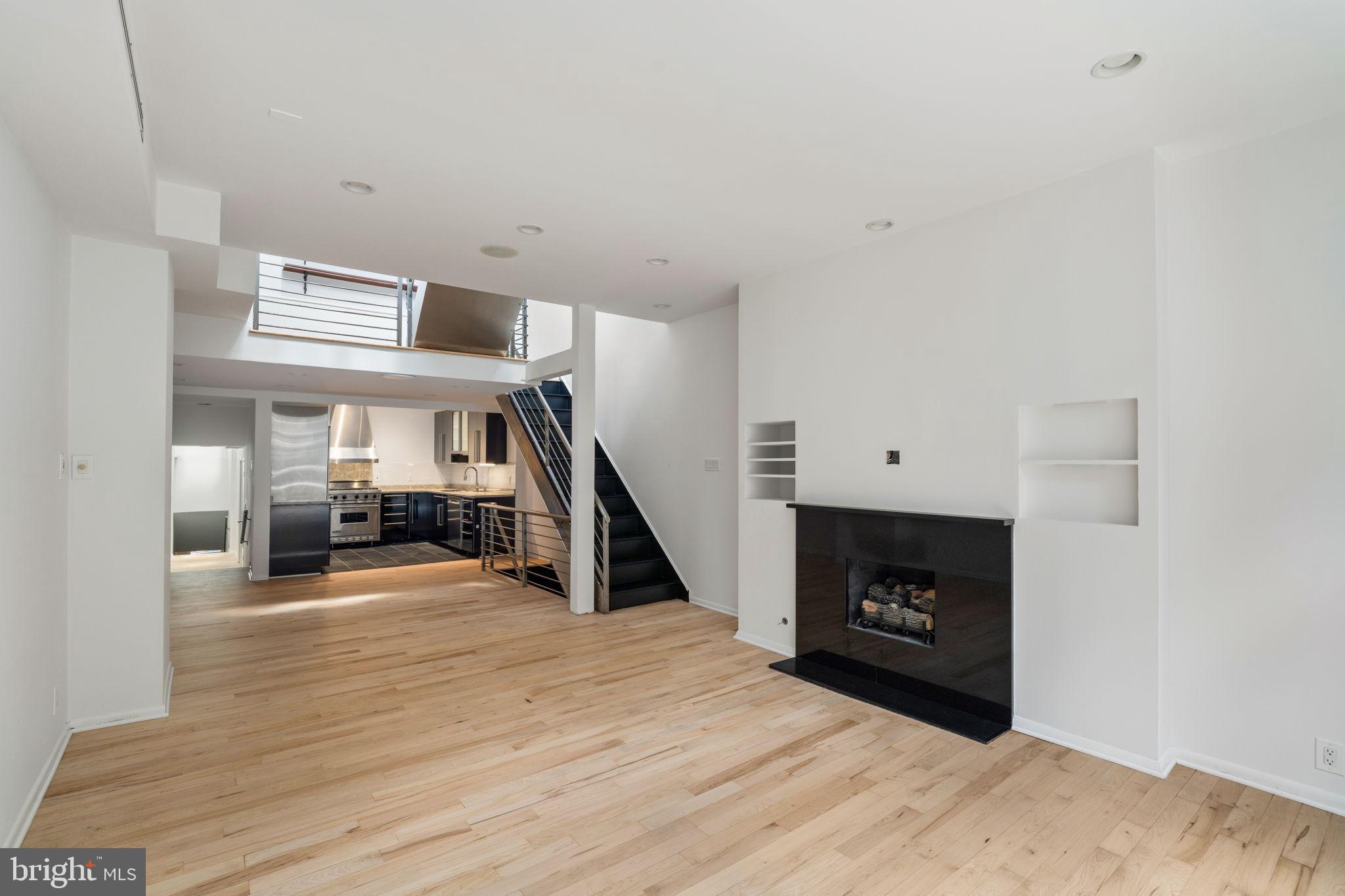 2036 Rittenhouse Square Philadelphia, PA 19103 - Photo 9 of 39 a living room with a fireplace furniture and a ceiling fan