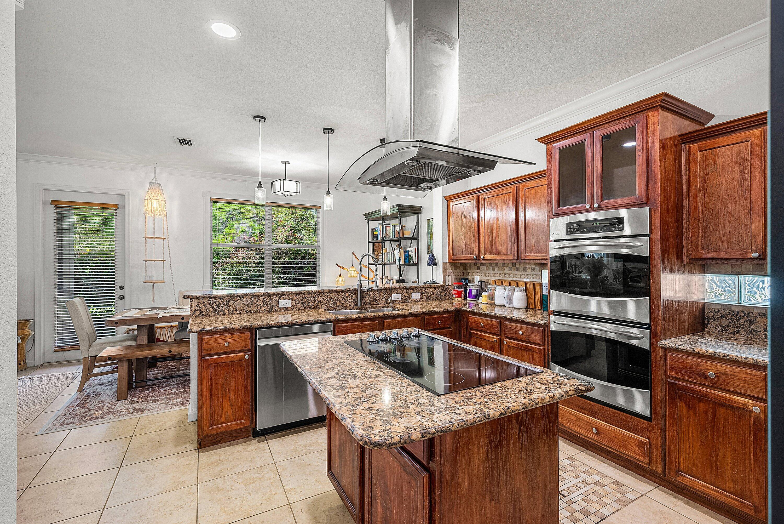1509 Sage Wood Court Riviera Beach, FL 33404 - Photo 20 of 59 a kitchen with a stove sink and cabinets