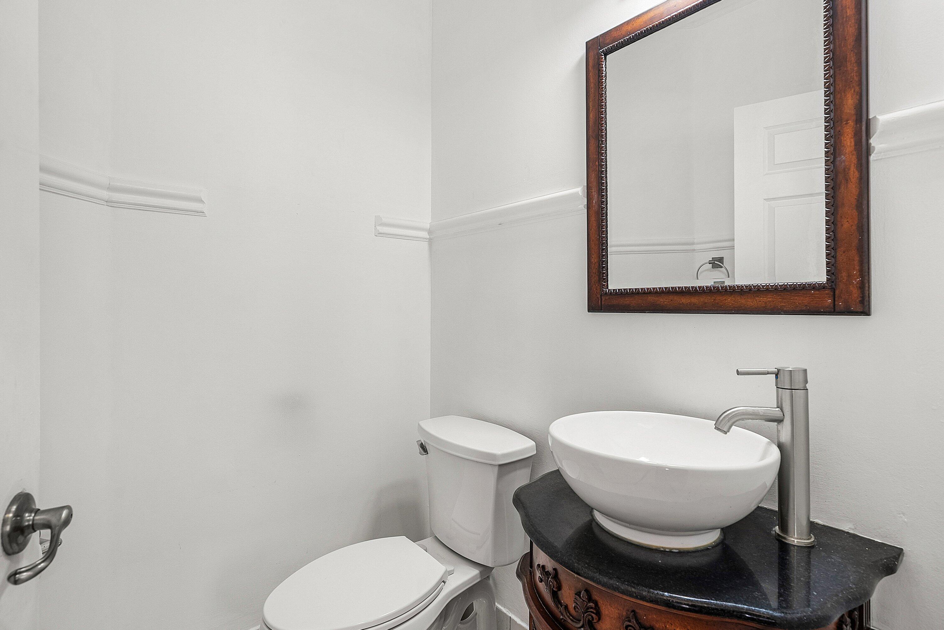 1509 Sage Wood Court Riviera Beach, FL 33404 - Photo 21 of 59 a white toilet sitting next to a bathroom sink