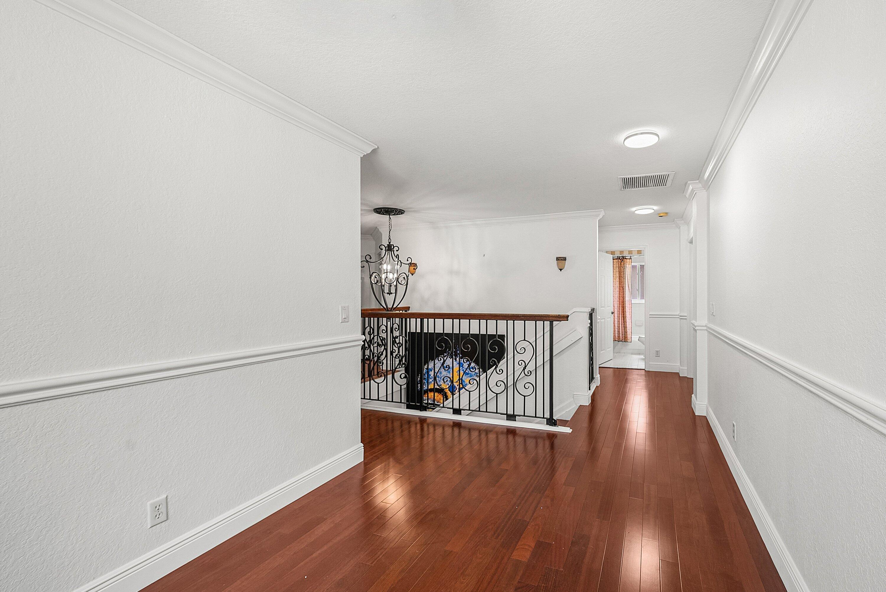1509 Sage Wood Court Riviera Beach, FL 33404 - Photo 23 of 59 a view of an empty room with wooden floor