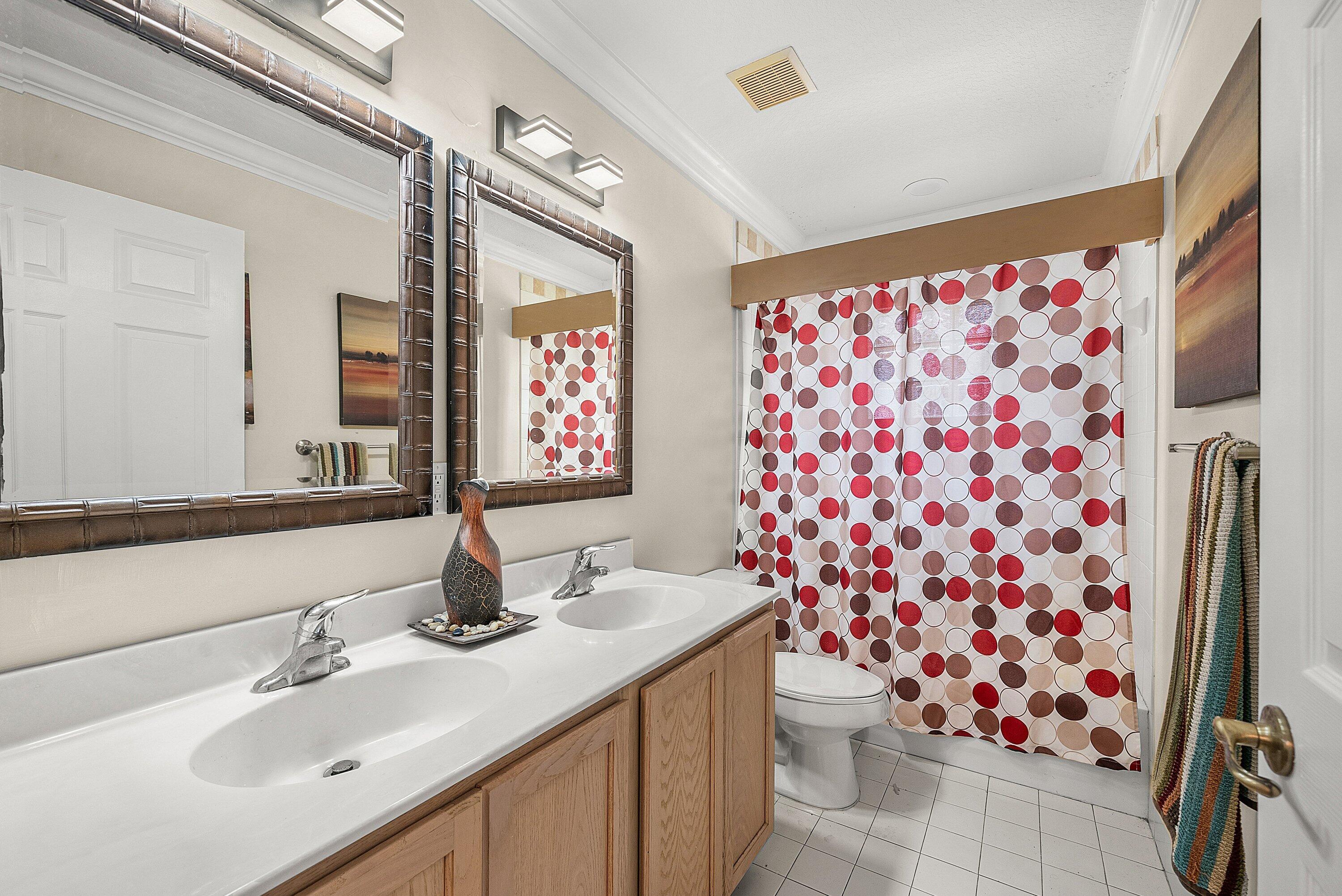 1509 Sage Wood Court Riviera Beach, FL 33404 - Photo 25 of 59 a bathroom with a sink toilet and shower