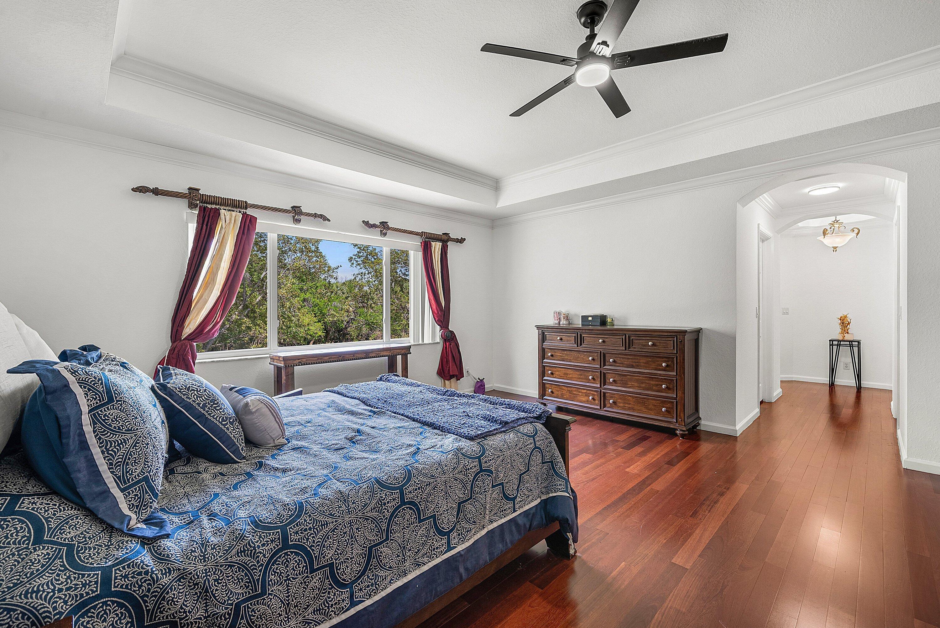 1509 Sage Wood Court Riviera Beach, FL 33404 - Photo 32 of 59 a bed room with a bed closet and a large window