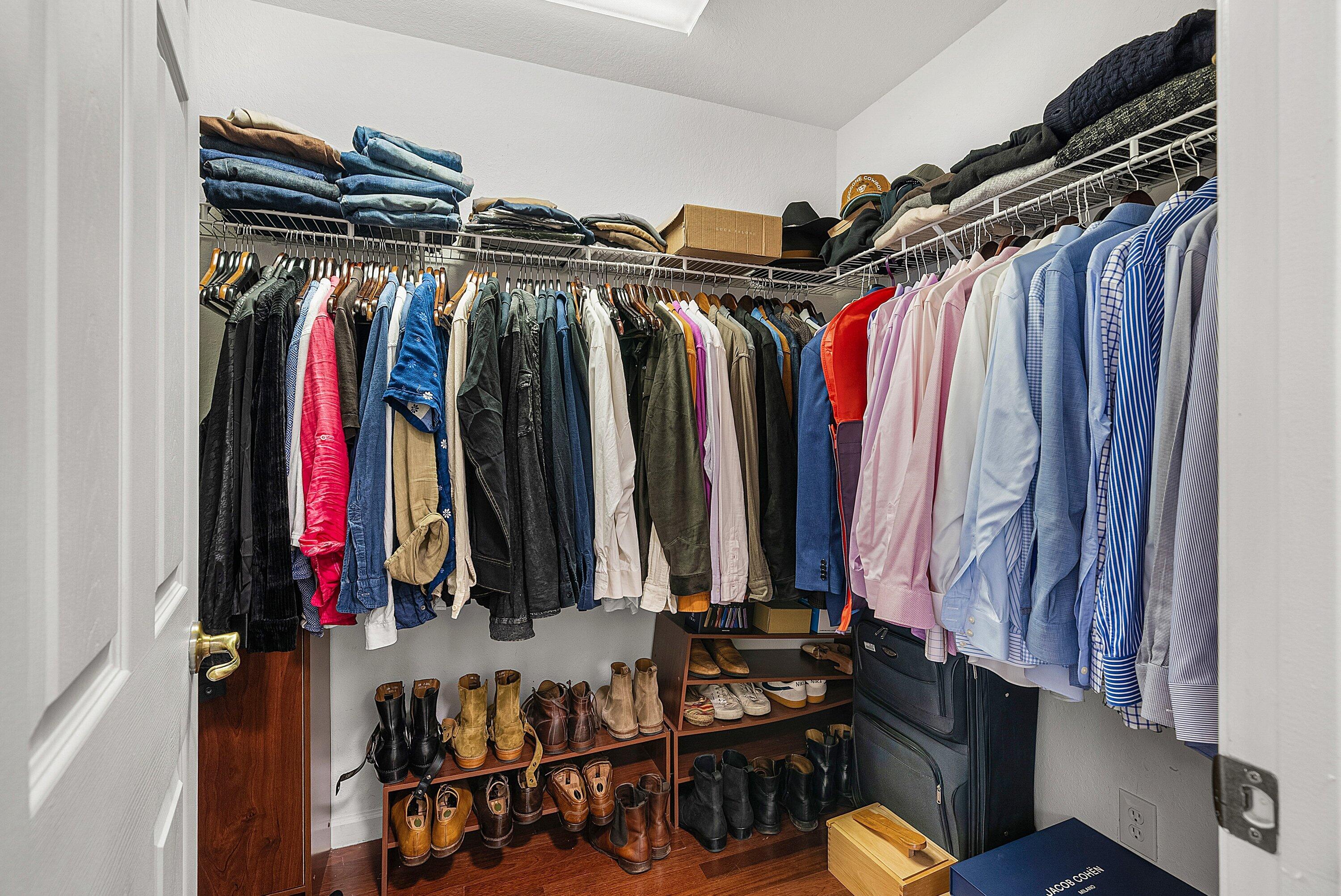 1509 Sage Wood Court Riviera Beach, FL 33404 - Photo 33 of 59 a view of walk in closet with clothes and shoes