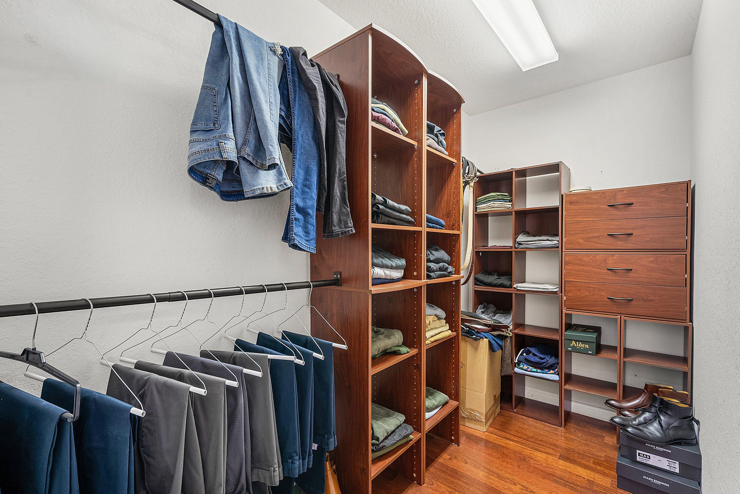 1509 Sage Wood Court Riviera Beach, FL 33404 - Photo 34 of 59 a view of walk in closet with clothes and shoes