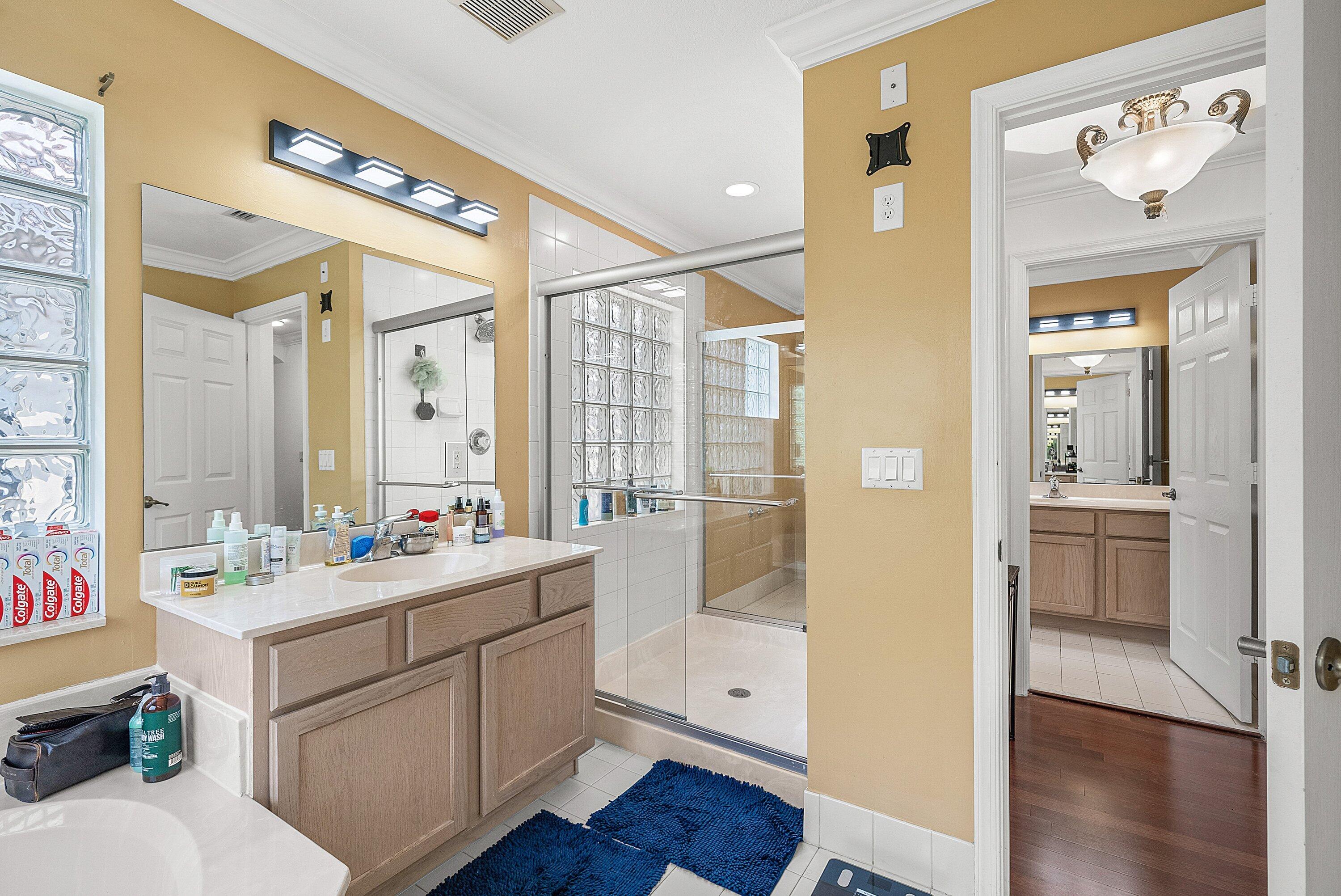 1509 Sage Wood Court Riviera Beach, FL 33404 - Photo 36 of 59 a bathroom with a double vanity sink mirror and shower