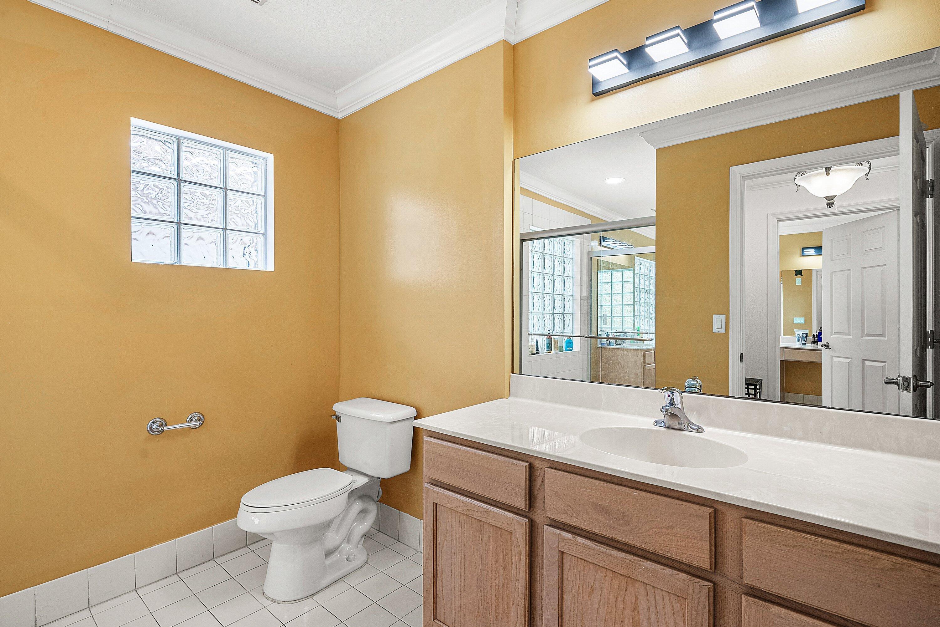 1509 Sage Wood Court Riviera Beach, FL 33404 - Photo 37 of 59 a bathroom with a sink and a toilet