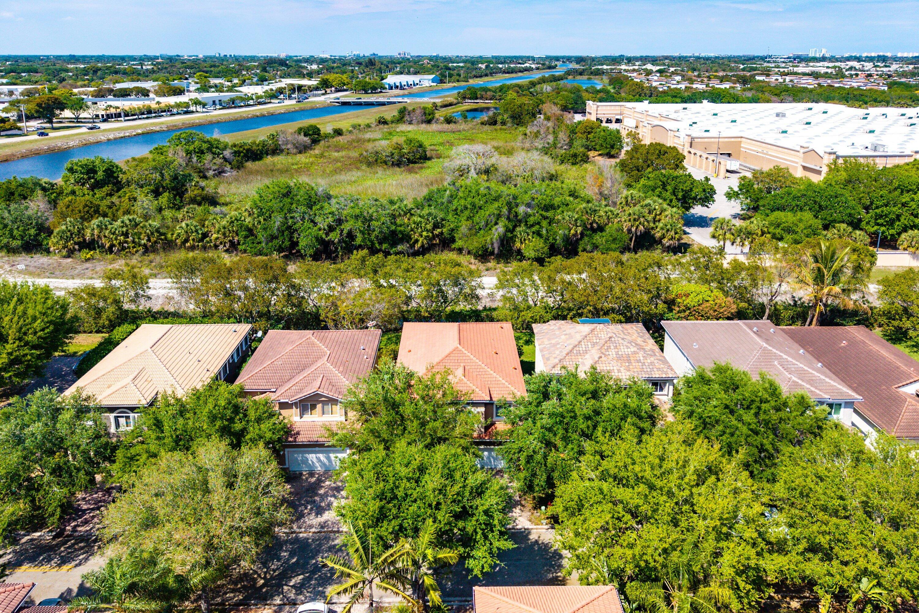 1509 Sage Wood Court Riviera Beach, FL 33404 - Photo 47 of 59 an aerial view of a houses with a yard and lake view